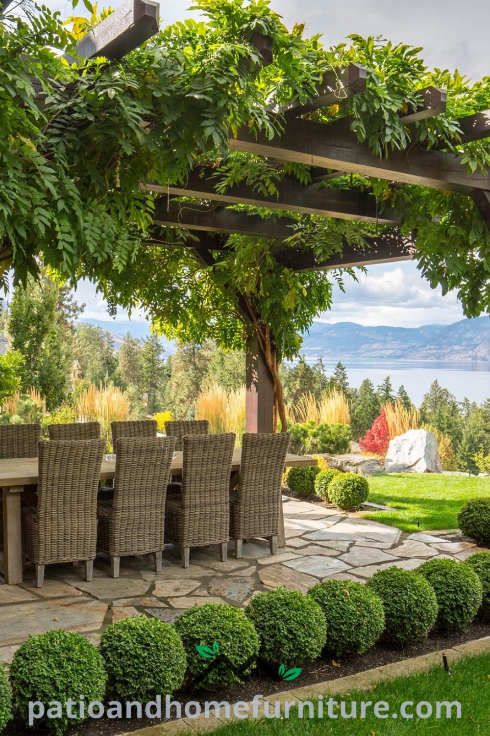 Outdoor dining area under a beautifully designed pergola, with a table, chairs, and water in the background, featuring floral accents and unique decor ideas for a cozy home environment, ideal for gatherings. Visit wellnesswink.com for more inspiring ideas.