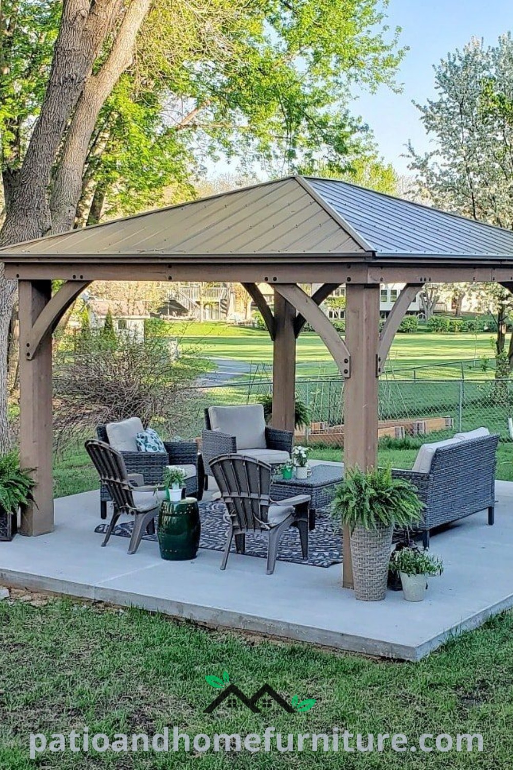 Cozy gazebo sitting on a cement slab in the middle of a park, surrounded by greenery, offering inspiring design ideas for outdoor living and backyard vibes at wellnesswink.com.
