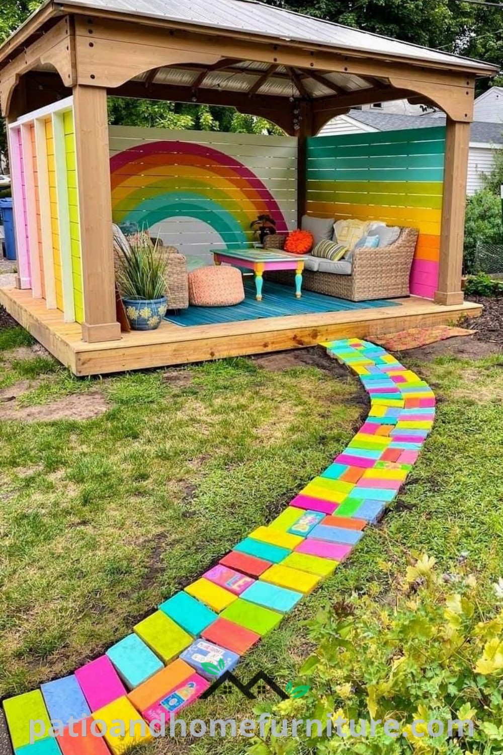 A colorful rainbow pathway leading to a wooden gazebo in a backyard filled with chairs and tables, creating a cozy outdoor play area, ideal for kids and family gatherings. Explore unique design ideas on wellnesswink.com.