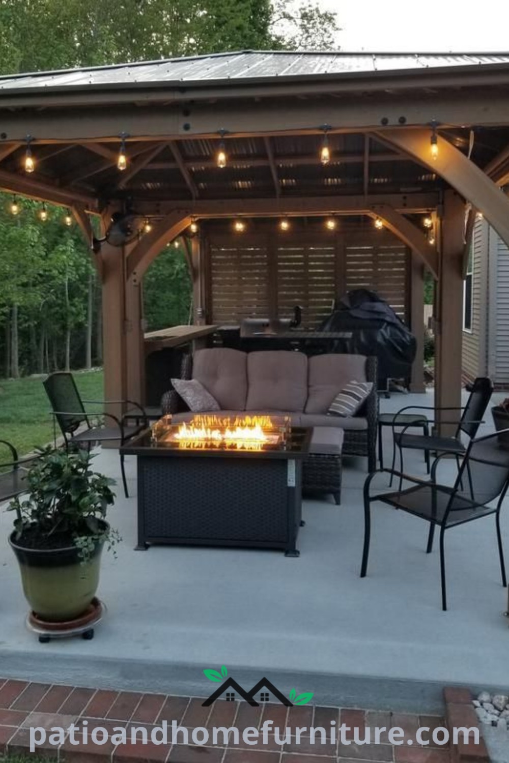 Cozy covered patio with furniture and lights, featuring a fire pit, ideal for outdoor gatherings and relaxation. Inspiring decor ideas for creating a unique and inviting backyard space can be found at wellnesswink.com.