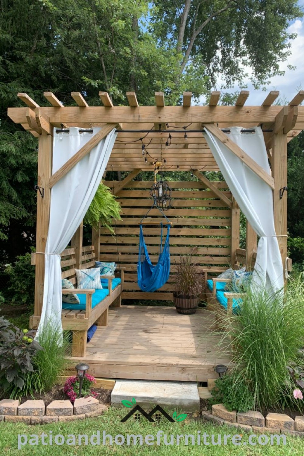 Wooden gazebo with white curtains and blue hammocks, designed as a serene outdoor yoga area, featuring elements of relaxation and meditation, showcasing cozy decor ideas from wellnesswink.com.