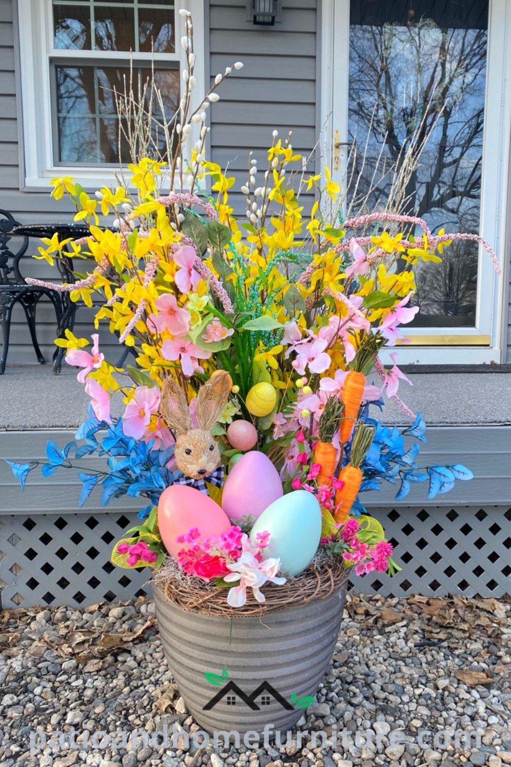 A basket filled with colorful Easter eggs and vibrant flowers, complemented by wooden bunnies and flower pots, creating a cozy and inviting front porch decor; perfect for inspiring unique ideas for your home at wellnesswink.com.