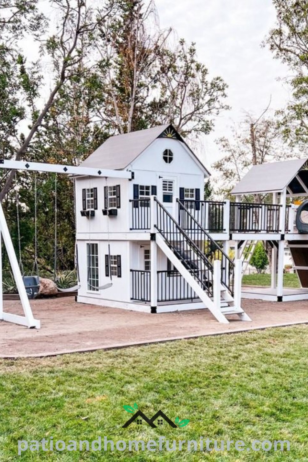 White house with a swing set and slide in the yard surrounded by trees, showcasing cozy backyard playground ideas for a vibrant family space, as featured on wellnesswink.com.