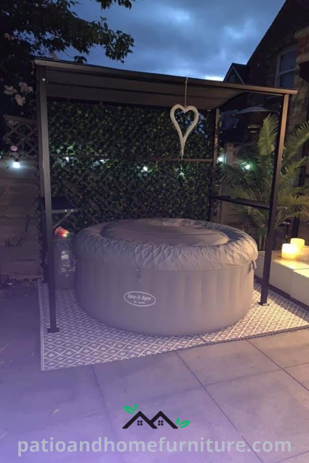 Inflatable hot tub on a patio at night, surrounded by ambient lighting and lush greenery, creating a cozy outdoor retreat for relaxation and enjoyment. Visit wellnesswink.com for more unique ideas and decor inspirations.