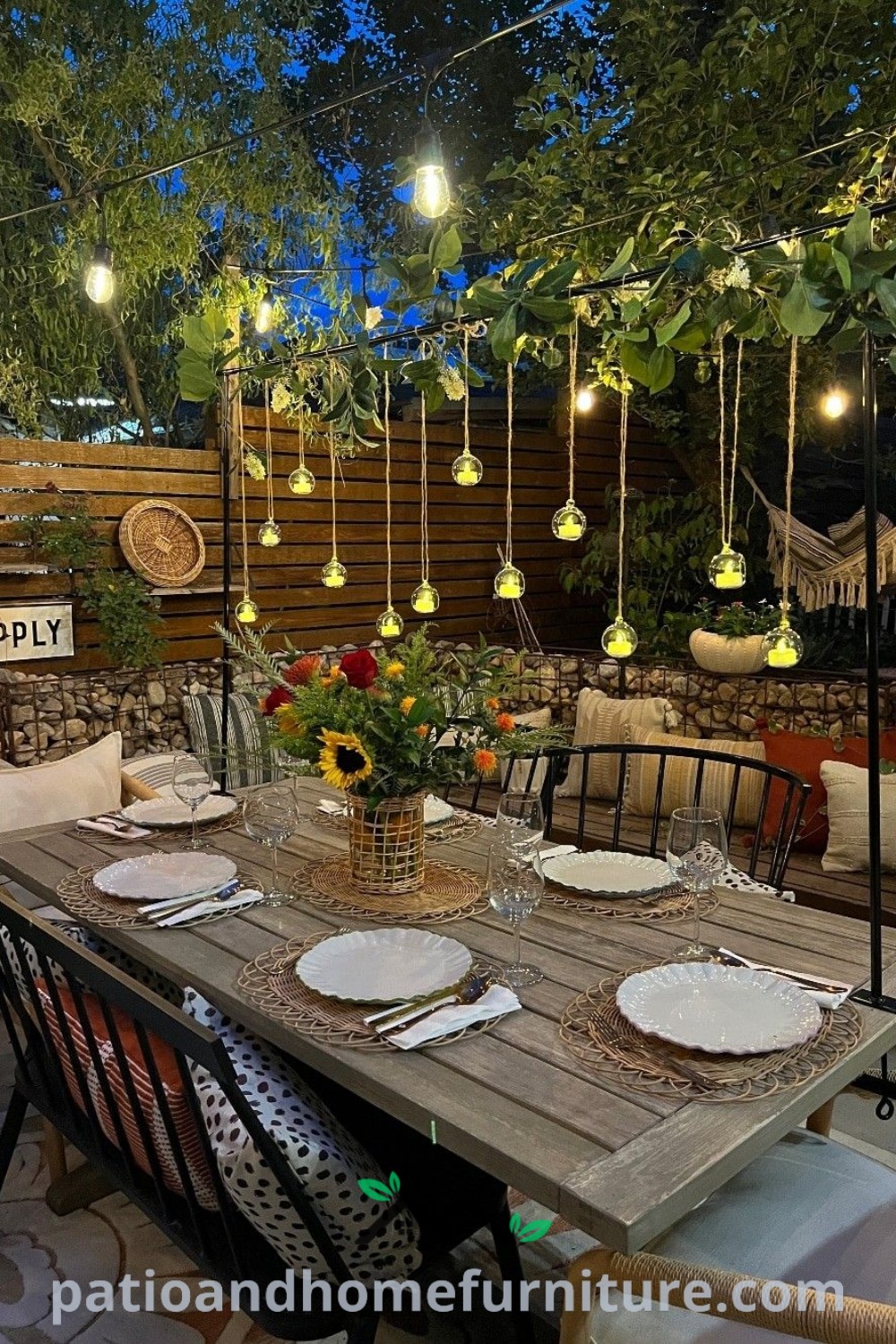 A cozy garden table beautifully set with plates and place settings, adorned with string lights and creative hanging decor ideas, perfect for outdoor dining at night, showcasing unique ideas for your home, featured on wellnesswink.com.