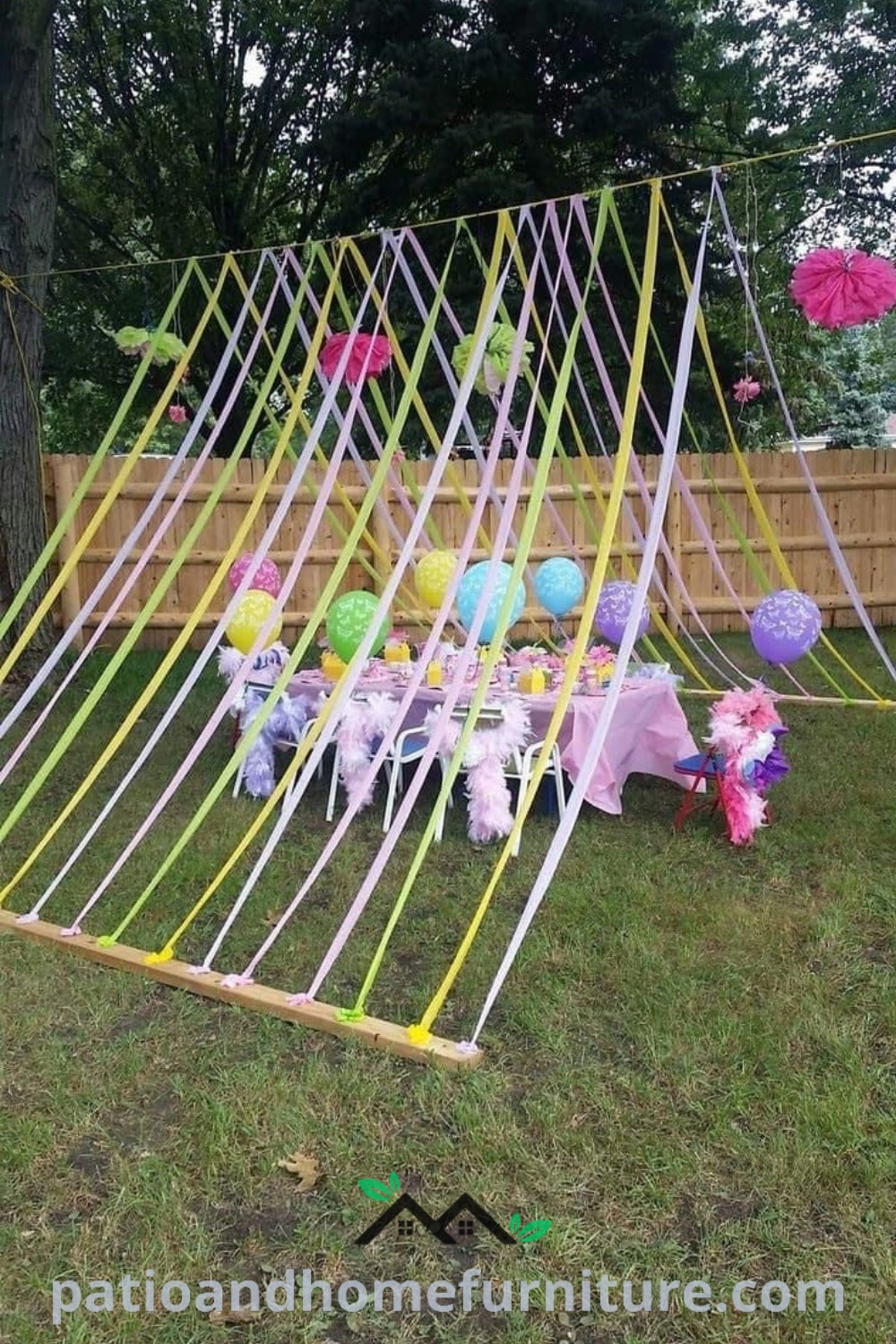 Colorful outdoor party setup featuring balloons and streamers shaped like a tent on a grassy area, ideal for kids’ birthday celebrations and picnics, with cozy decor ideas that inspire cheerful gatherings. Visit wellnesswink.com for more decor inspirations.