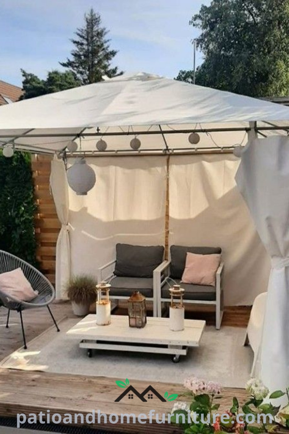 Cozy outdoor living area with white curtains on the gazebo roof and comfortable furniture, perfect for reading and relaxation, showcasing unique decor ideas for a charming backyard, featured on wellnesswink.com.