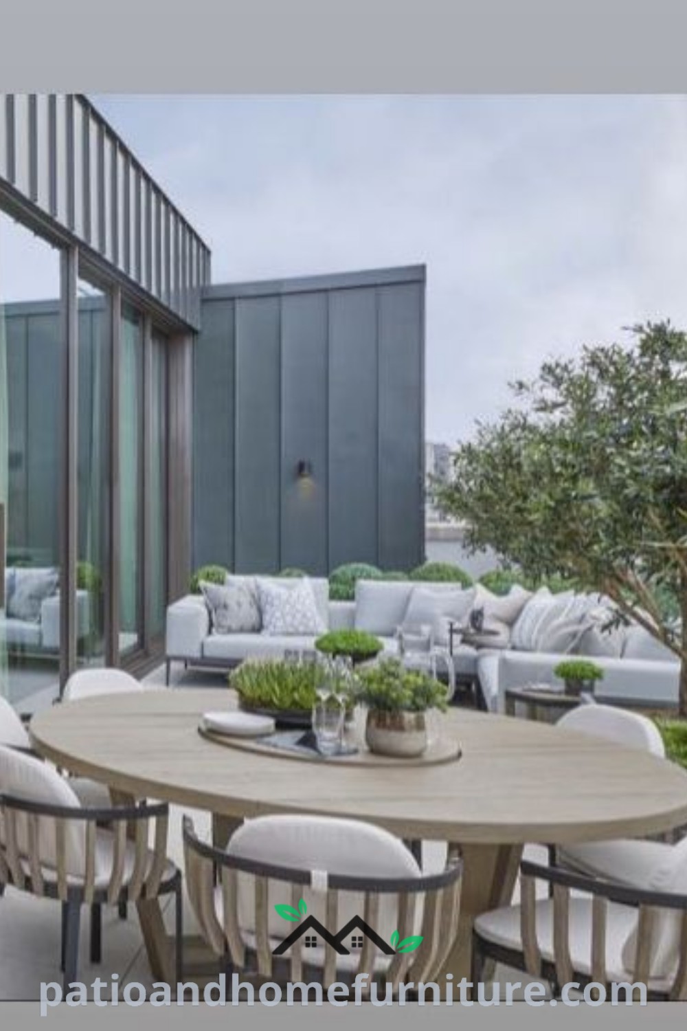 Outdoor dining table with white chairs and potted plants on a cozy patio, ideal for inspiring decor ideas and outdoor gatherings, featured on wellnesswink.com.