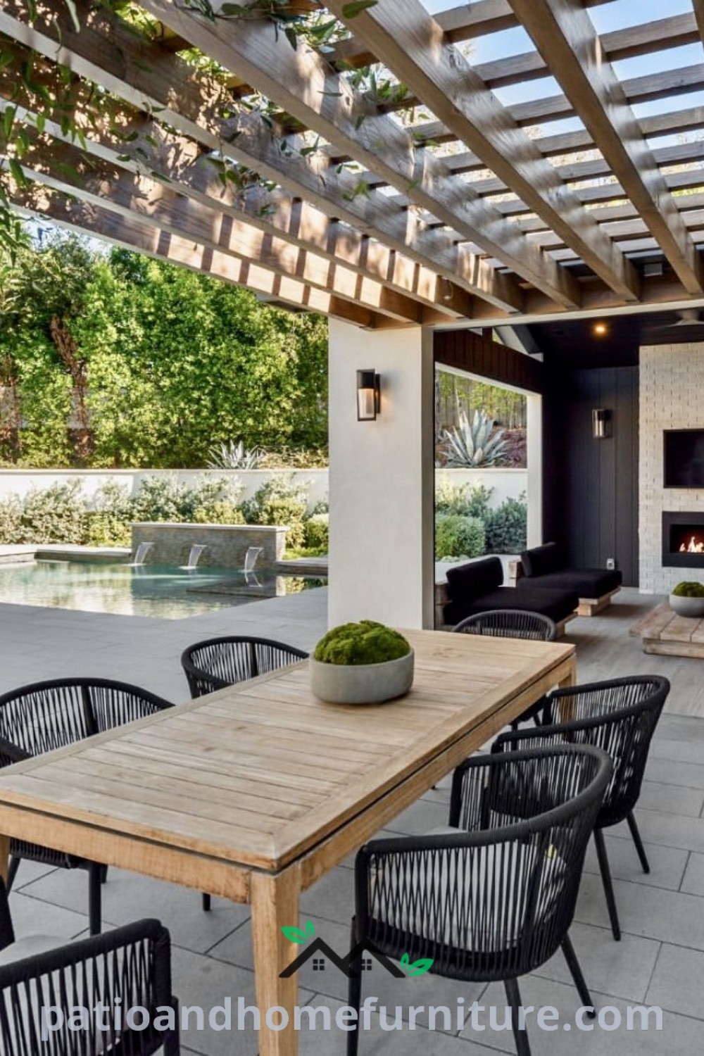 Outdoor dining area featuring a wooden table and chairs, surrounded by lush greenery and decorative elements, showcasing cozy ideas for backyard decor inspirations at wellnesswink.com.