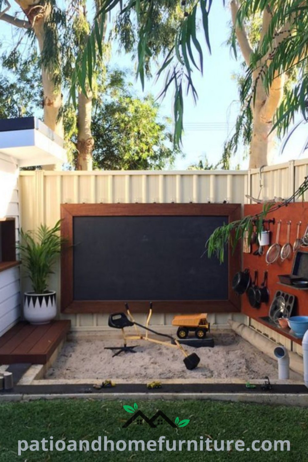 Backyard play area with a chalkboard, colorful potted plants, cozy seating, and decorative elements, providing inspiring ideas for creating a cozy home space that encourages outdoor play and family bonding, wellnesswink.com.