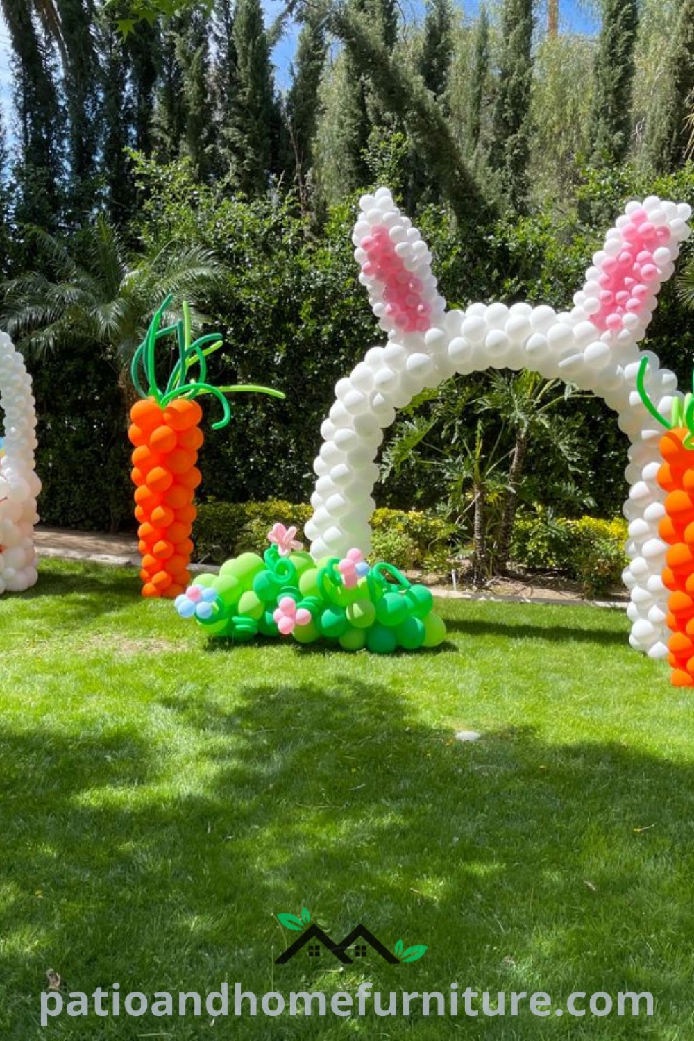 Inflatable bunny and carrot arch surrounded by colorful spring balloons on a lawn with palm trees, showcasing vibrant Easter decorations for an outdoor party, featured on wellnesswink.com.