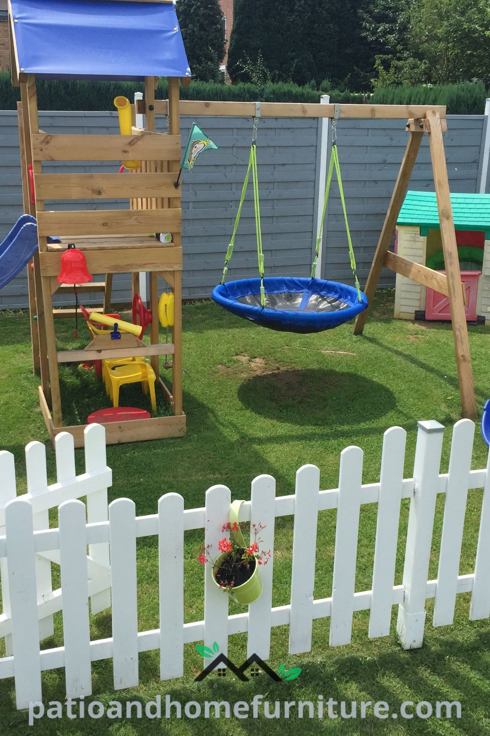 Fenced outdoor play area with swings, slides, and play equipment for children, creating a safe and inviting space for outdoor fun, with cozy ideas for parents to relax while supervising playtime. Visit wellnesswink.com for more inspiring designs and decor ideas.