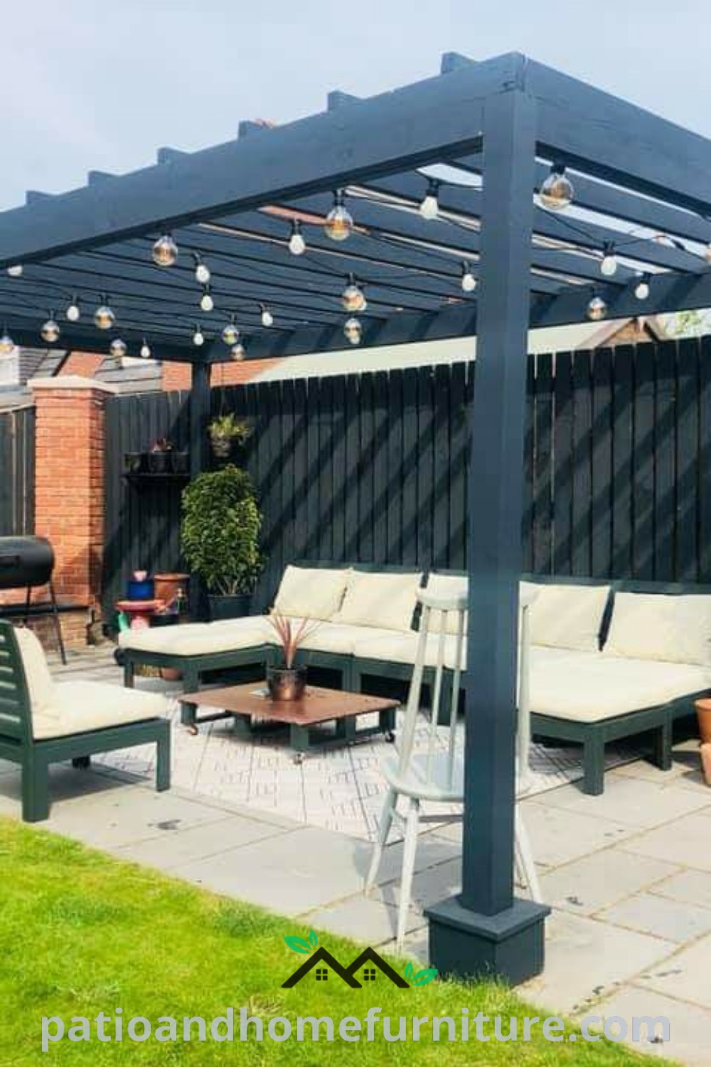 Outdoor living area featuring cozy couches, stylish tables, vibrant potted plants, and a black pergola providing shade, showcasing unique design ideas for a charming backyard oasis, perfect for relaxation and entertaining, wellnesswink.com.