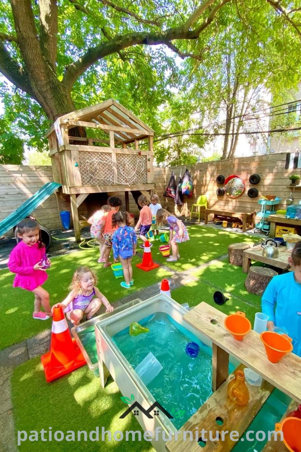 Children engaging in play at an outdoor area with sand and water toys on the grass, surrounded by trees, creating a cozy and inviting atmosphere for preschool and daycare activities, with ideas for enhancing outdoor learning spaces on wellnesswink.com.