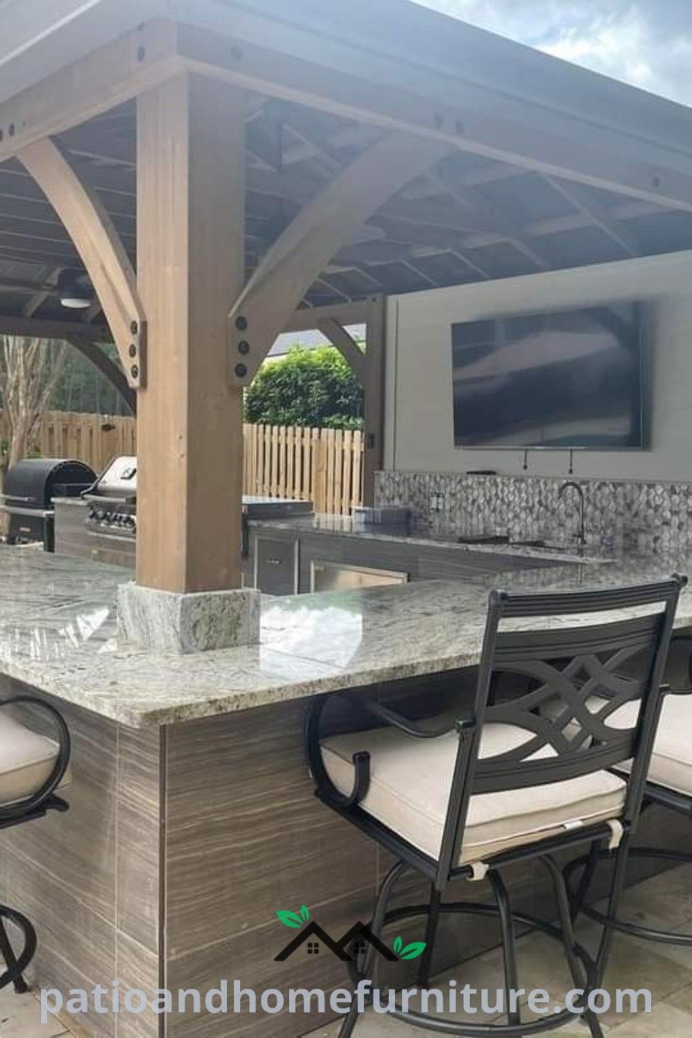 A stylish outdoor kitchen with bar seating and a television, surrounded by cozy patio furniture and wood accents, offering inspiring design ideas for outdoor gatherings at wellnesswink.com.