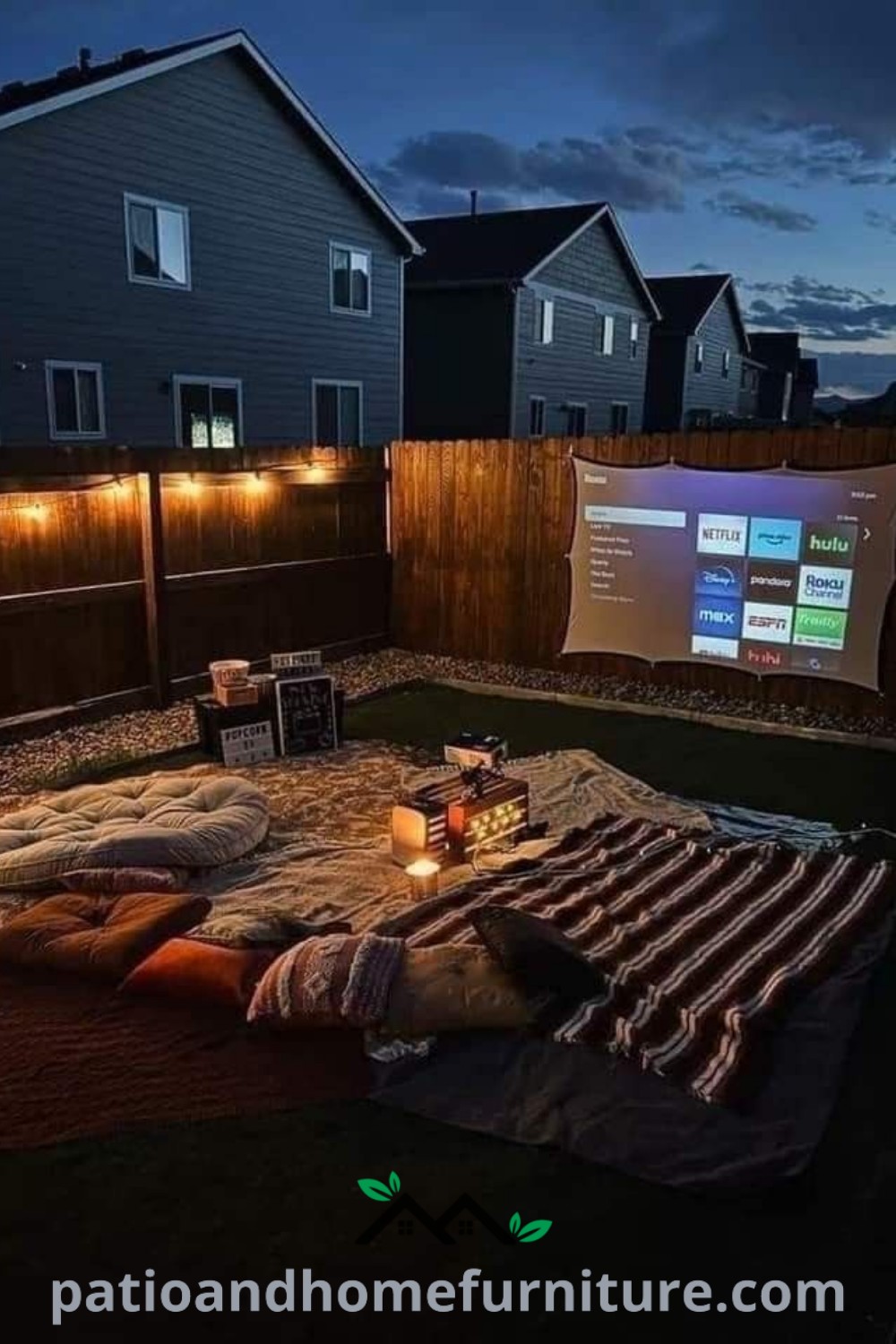 Outdoor movie screen setup in a backyard at night with cozy seating, string lights, and a projector, creating an inviting atmosphere for a movie date night; find more cozy ideas at wellnesswink.com.