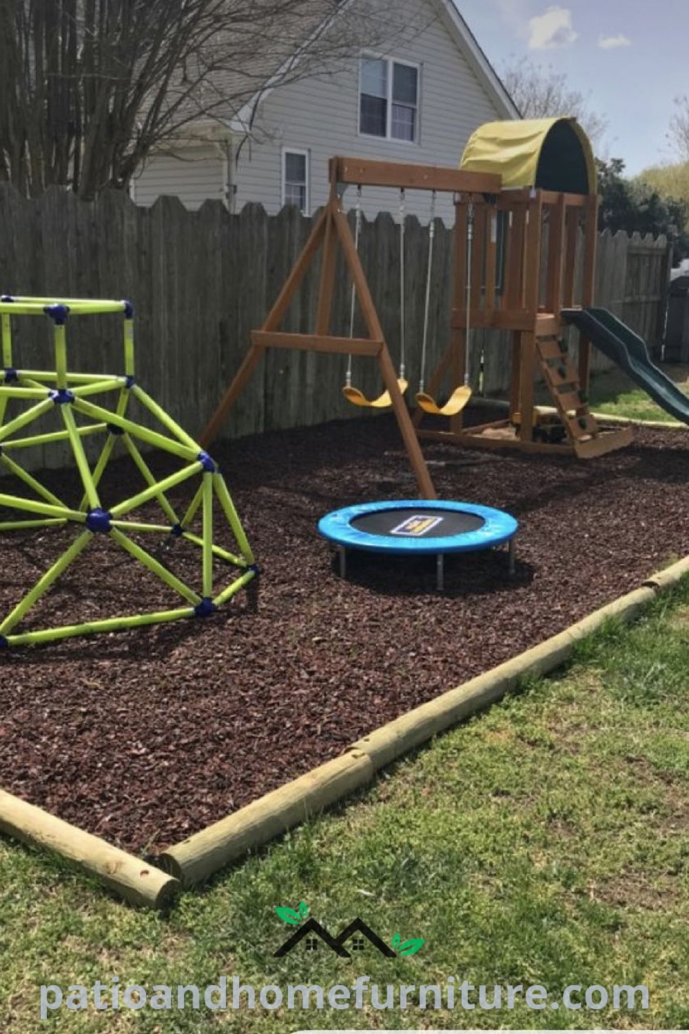 Backyard play area with a swing set, slide, and climbing frame surrounded by mulch, designed as an inviting and cozy space for kids to enjoy outdoor activities, ideal for creative play and family bonding, featured on wellnesswink.com.
