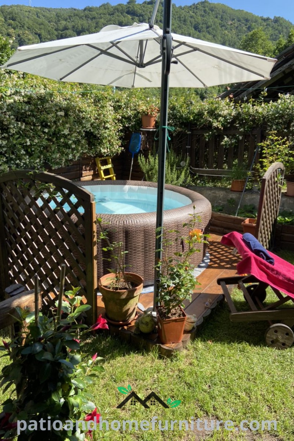 Outdoor hot tub surrounded by lawn chairs and an umbrella, set in a lush yard, offering a cozy relaxation space, complemented by greenery and decor ideas found on wellnesswink.com.