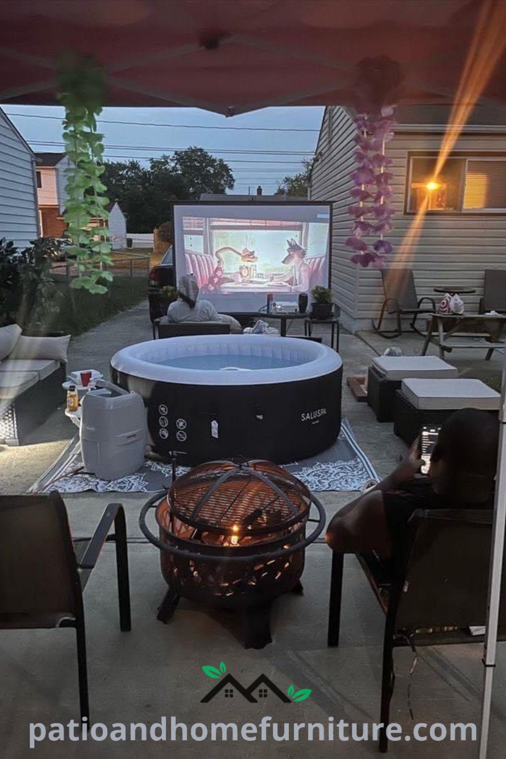 Cozy hot tub arrangement in a backyard with chairs around it and a decorative screen on the back wall, showcasing inviting design ideas for an inspiring outdoor space at wellnesswink.com.