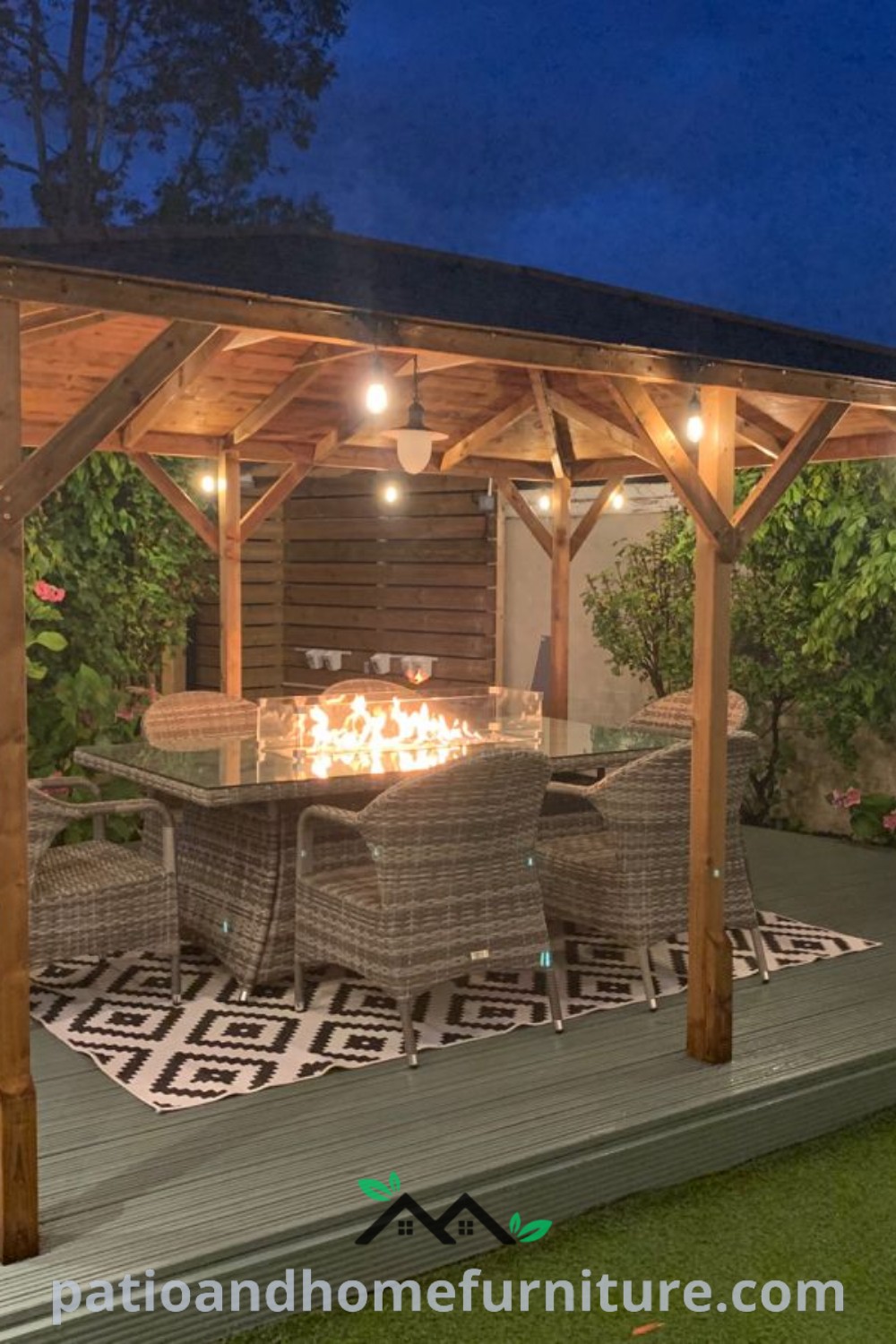 A cozy patio setup with a table and chairs under a warm fire pit, surrounded by lush plants, highlighting unique ideas for outdoor decor and design inspirations, perfect for creating a charming retreat at home. Visit wellnesswink.com for more cozy ideas.