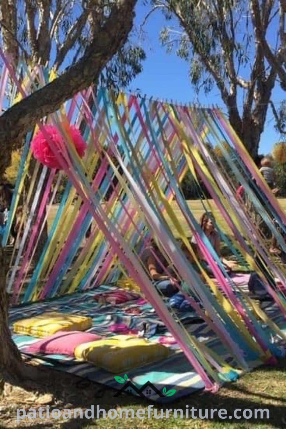 A group of people standing next to a tree in a park decorated with balloons and streamers, celebrating a birthday party, with lively colors and joyful expressions, inspiring cozy and festive decor ideas for outdoor celebrations on wellnesswink.com.