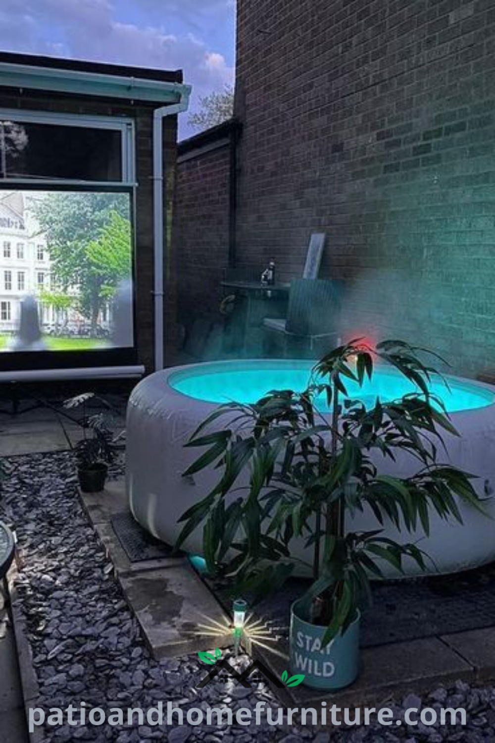 Outdoor hot tub set amidst a beautifully decorated patio area with lush plants and potted greenery, creating a cozy and inviting atmosphere for relaxation and leisure, featured on wellnesswink.com.