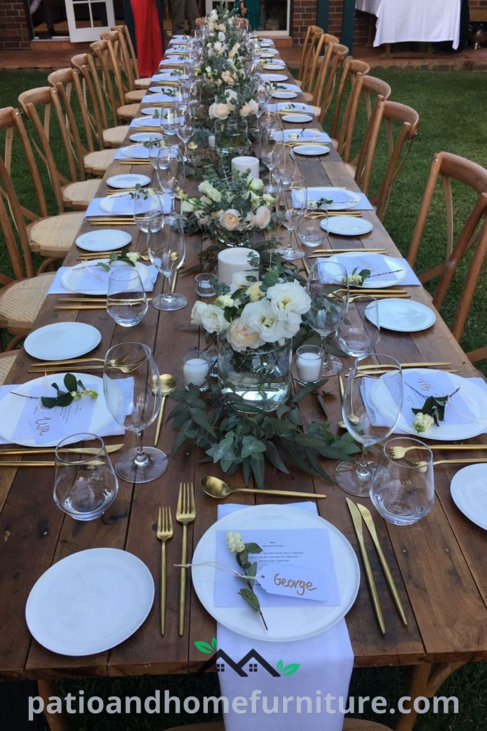 Long outdoor wedding reception table elegantly set with white plates and silverware, complemented by charming garden decorations, showcasing cozy ideas for a beautiful event at wellnesswink.com.