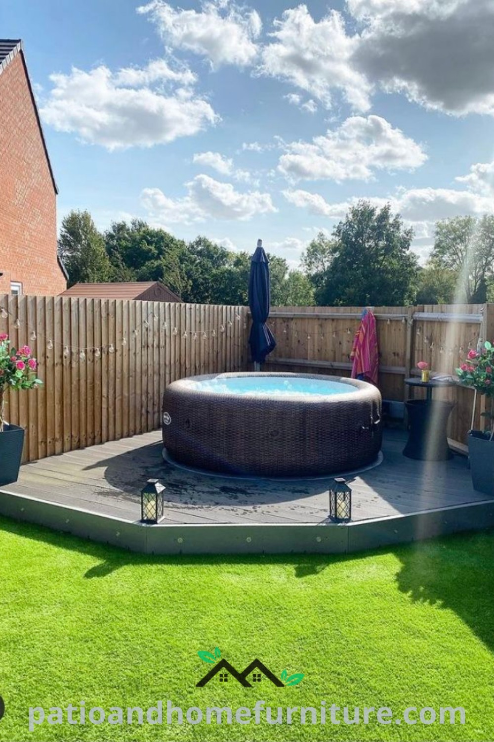 Outdoor space featuring a small jacuzzi with lush landscaping, cozy seating, and decorative elements like plants and lanterns, creating an inviting mini spa atmosphere for relaxation and enjoyment. Visit wellnesswink.com for more cozy home decor ideas.