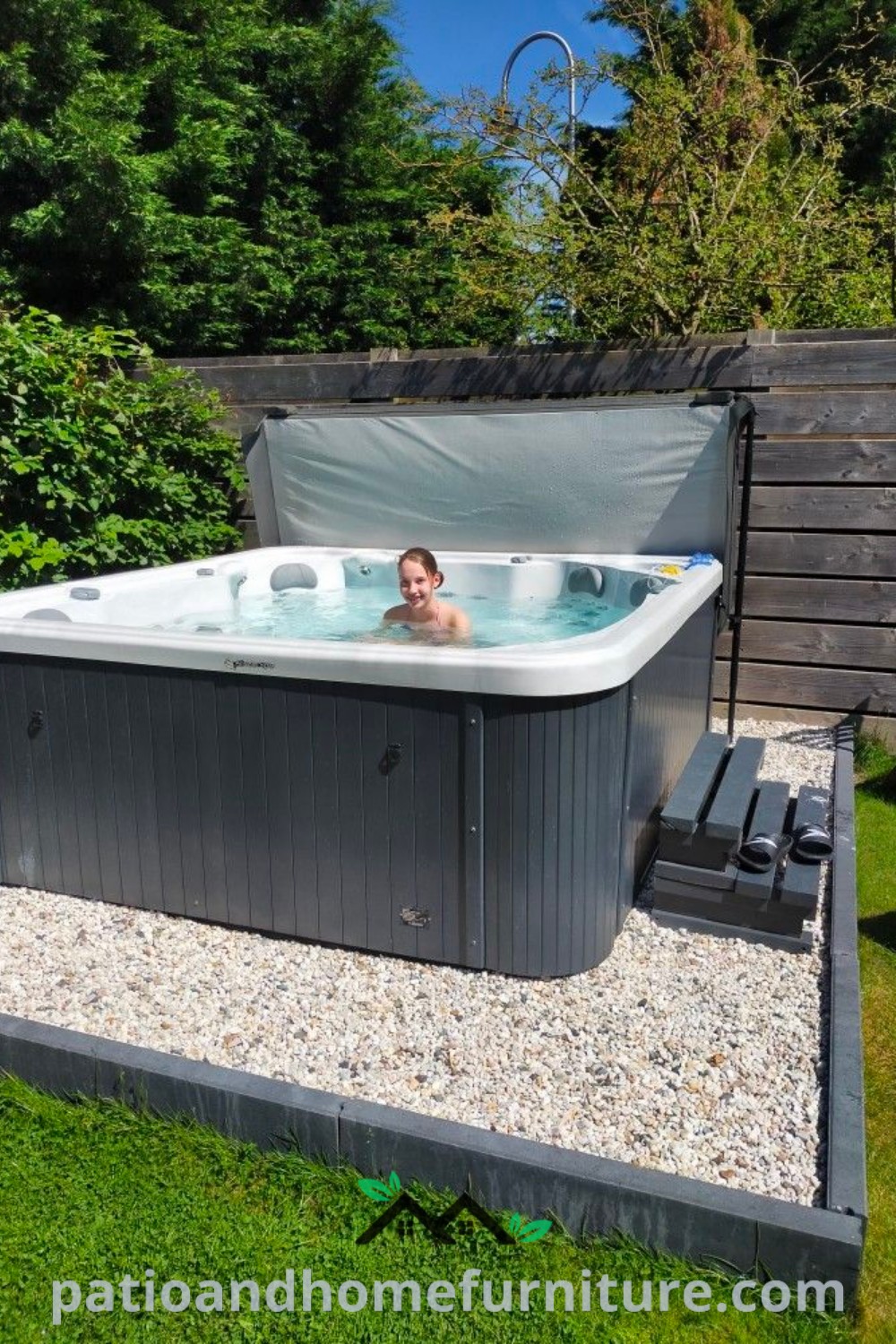 A man enjoying a hot tub on a lush green field, exemplifying cozy home ideas with spa pergola decor and landscaping inspirations from wellnesswink.com.