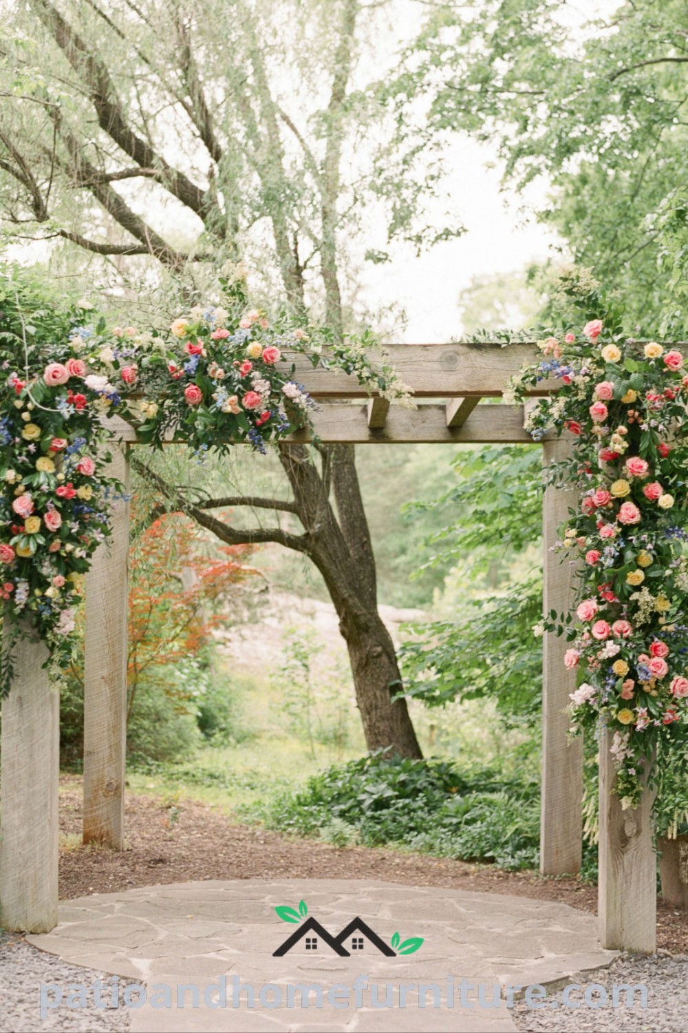 Outdoor wedding ceremony featuring a floral-covered pergola surrounded by greenery and trees, creating a cozy atmosphere with charming decor ideas for your special day, wellnesswink.com.