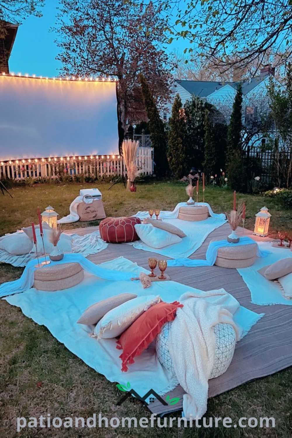 Outdoor movie setup with pillows, blankets, and candles on the grass in front of a house, creating a cozy atmosphere ideal for outdoor gatherings and movie nights, featuring inspiring decor ideas from wellnesswink.com.