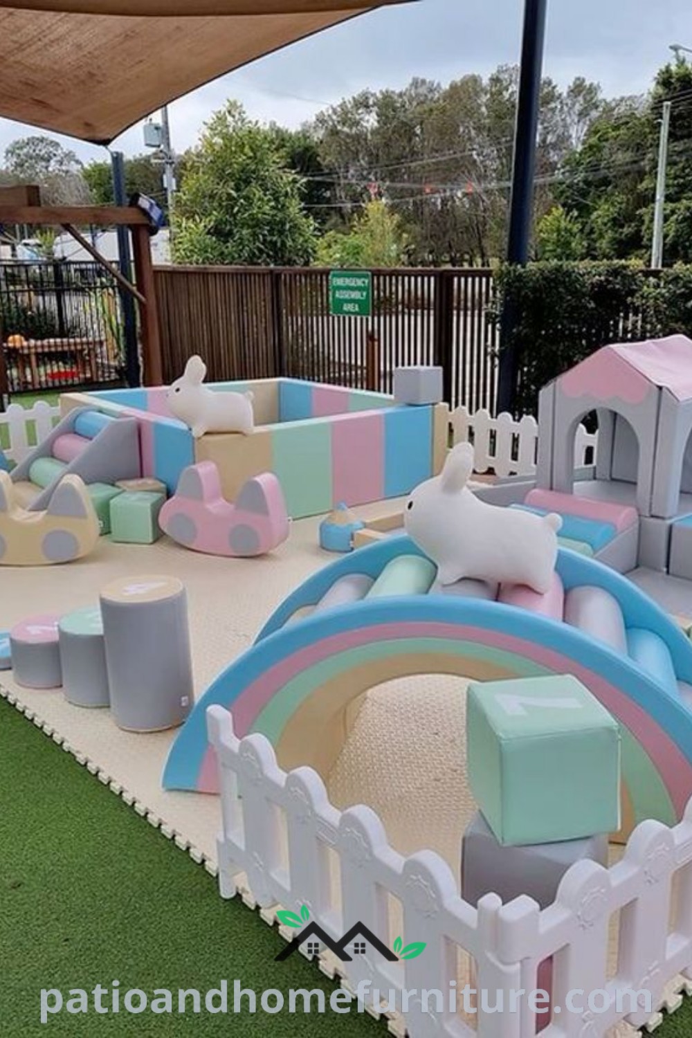 Inflatable soft play area set on artificial grass, surrounded by wooden fences, featuring colorful play equipment for kids, with decor inspirations for a cozy birthday party setup at wellnesswink.com.