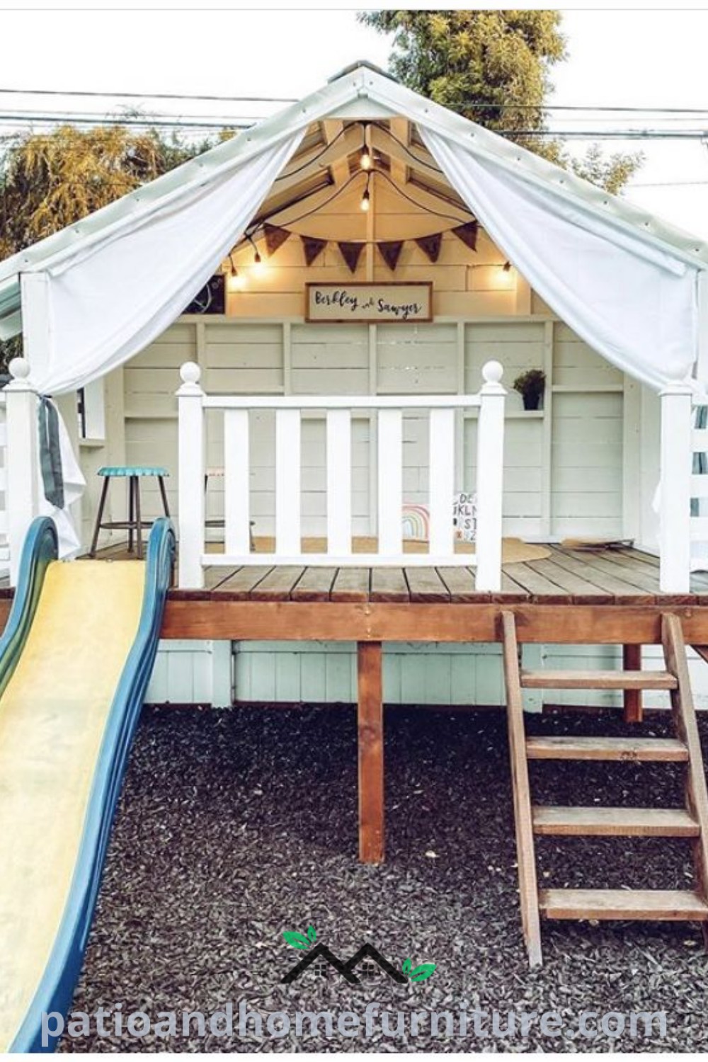 Kids playground in a backyard with a colorful slide in front of a white house, showcasing cozy design ideas and unique inspirations for creating a playful space on wellnesswink.com.