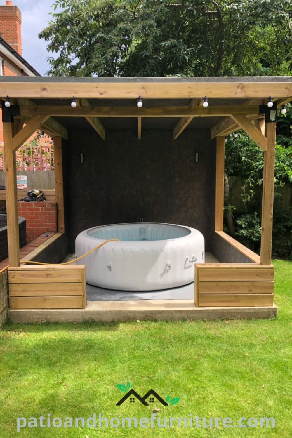 Cozy hot tub in a beautifully landscaped yard, surrounded by plants and ambient seating, offering a perfect relaxation spot and inspiring ideas for backyard decor at wellnesswink.com.