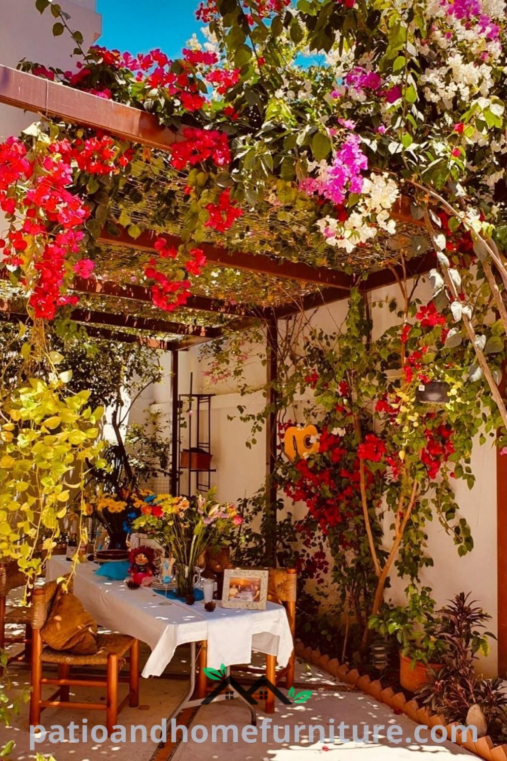Charming outdoor dining area with a central table surrounded by potted plants and a flower-adorned roof, providing cozy design ideas and inspirations for your home, featured on wellnesswink.com.