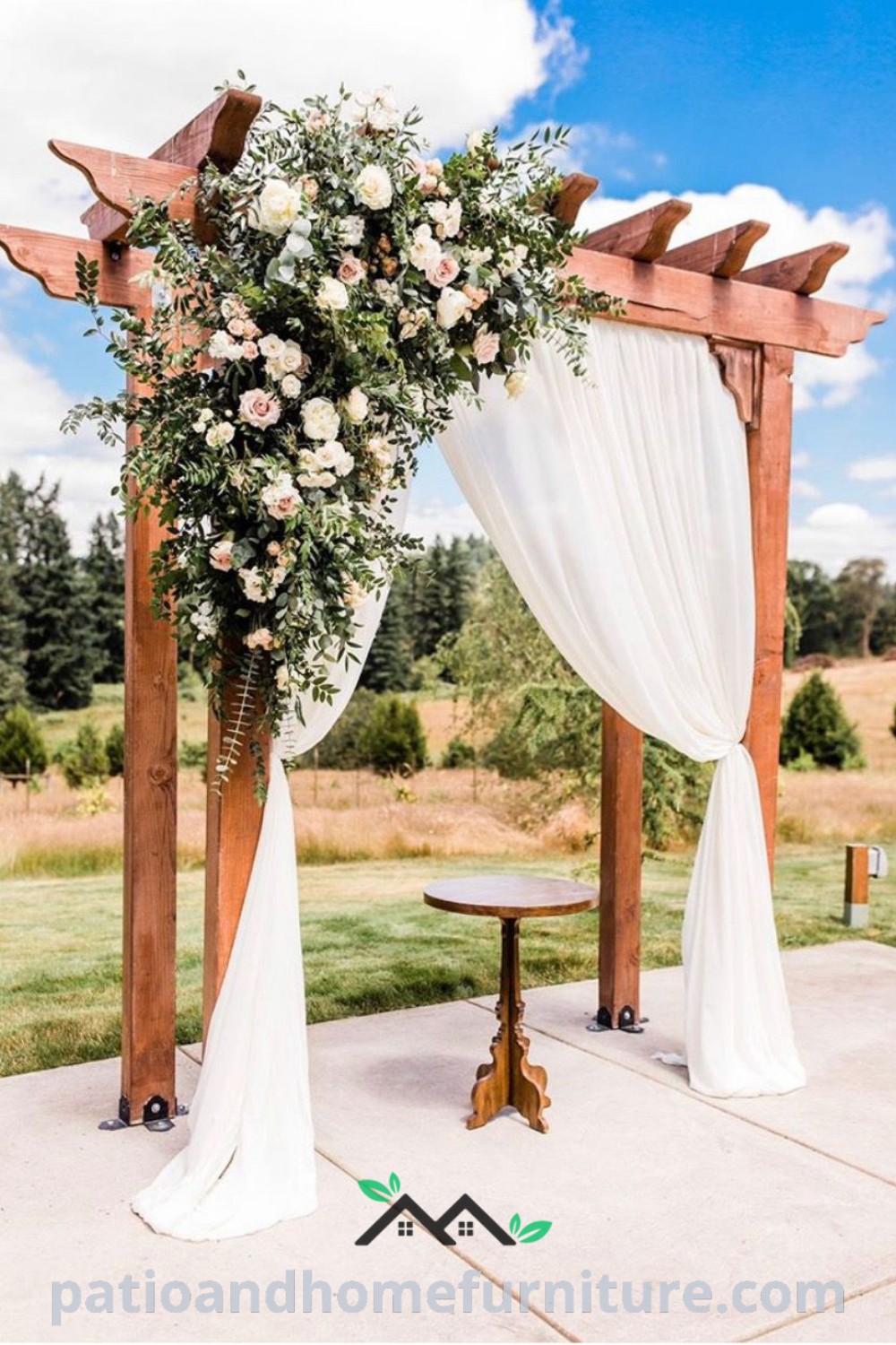 Outdoor wedding ceremony with a beautiful arch decorated with white draping and colorful flowers, surrounded by lush greenery, offering cozy design ideas for a perfect wedding setting on wellnesswink.com.