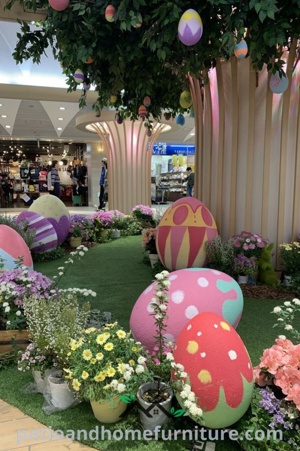 Interior of a mall decorated with colorful Easter eggs and flowers in potted planters, showcasing cozy decor ideas for Easter celebrations, including vibrant colors and festive elements, as seen on wellnesswink.com.
