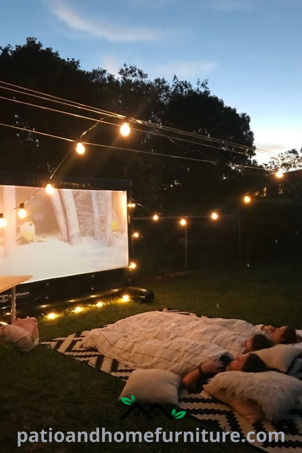 Cozy outdoor movie night setup in a backyard, featuring string lights, soft pillows on the ground, and a warm, inviting atmosphere perfect for friendly gatherings or romantic evenings, providing unique decor ideas and inspiration for your home at wellnesswink.com.