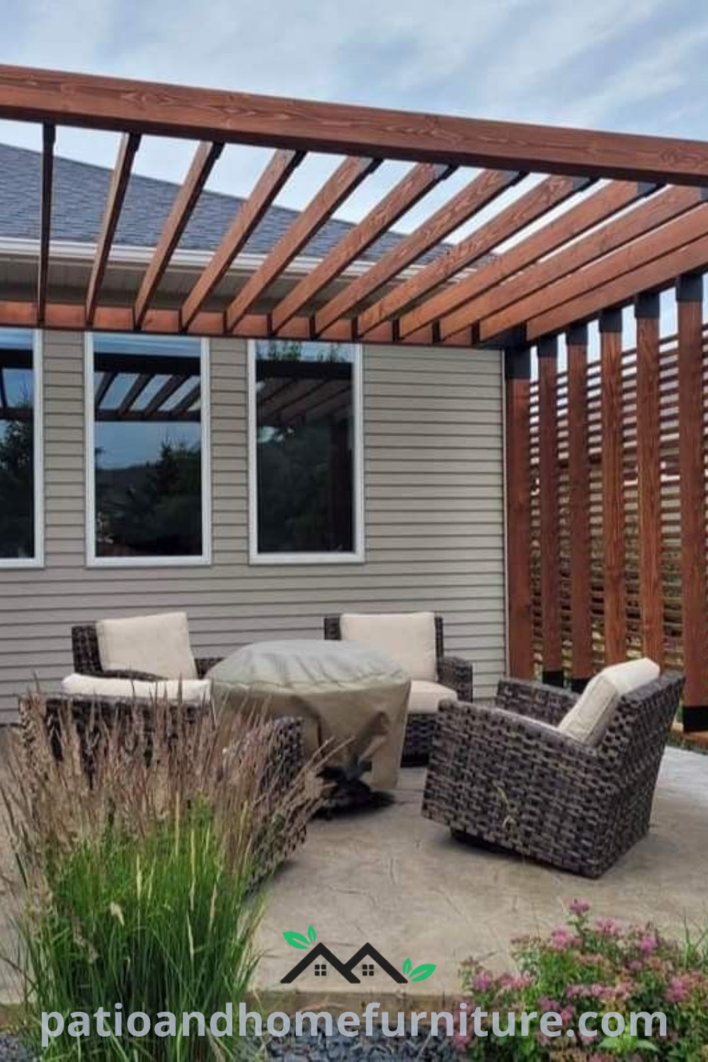 Patio with chairs and a modern pergola in front of a house, showcasing cozy ideas for outdoor relaxation, perfect for creating a charming backyard retreat, featured on wellnesswink.com.