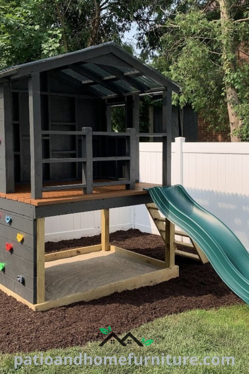 Cozy backyard play structure featuring a slide and climbing wall adjacent to a white fence, providing an inviting space for children, with inspiring ideas for outdoor fun and creativity for your home at wellnesswink.com.