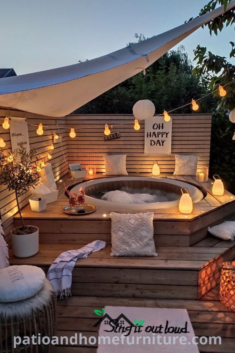Hot tub on a wooden deck surrounded by candles and pillows, with ambient lighting creating a cozy atmosphere, offering inspiring decor ideas for a serene backyard oasis at wellnesswink.com.
