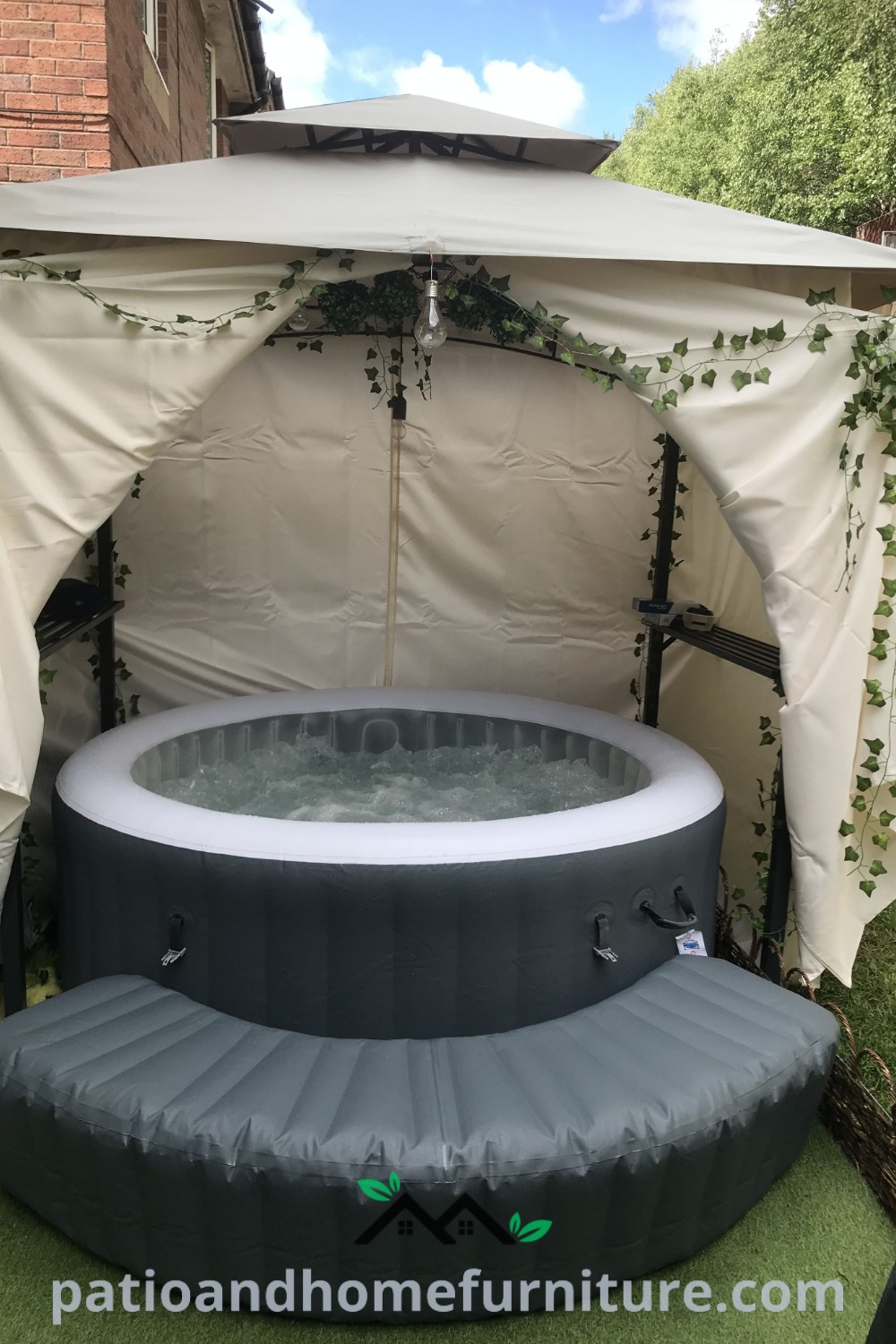 Inflatable hot tub next to a gazebo with curtains, showcasing cozy ideas for a backyard oasis, providing unique decor inspirations for outdoor living, featured on wellnesswink.com.