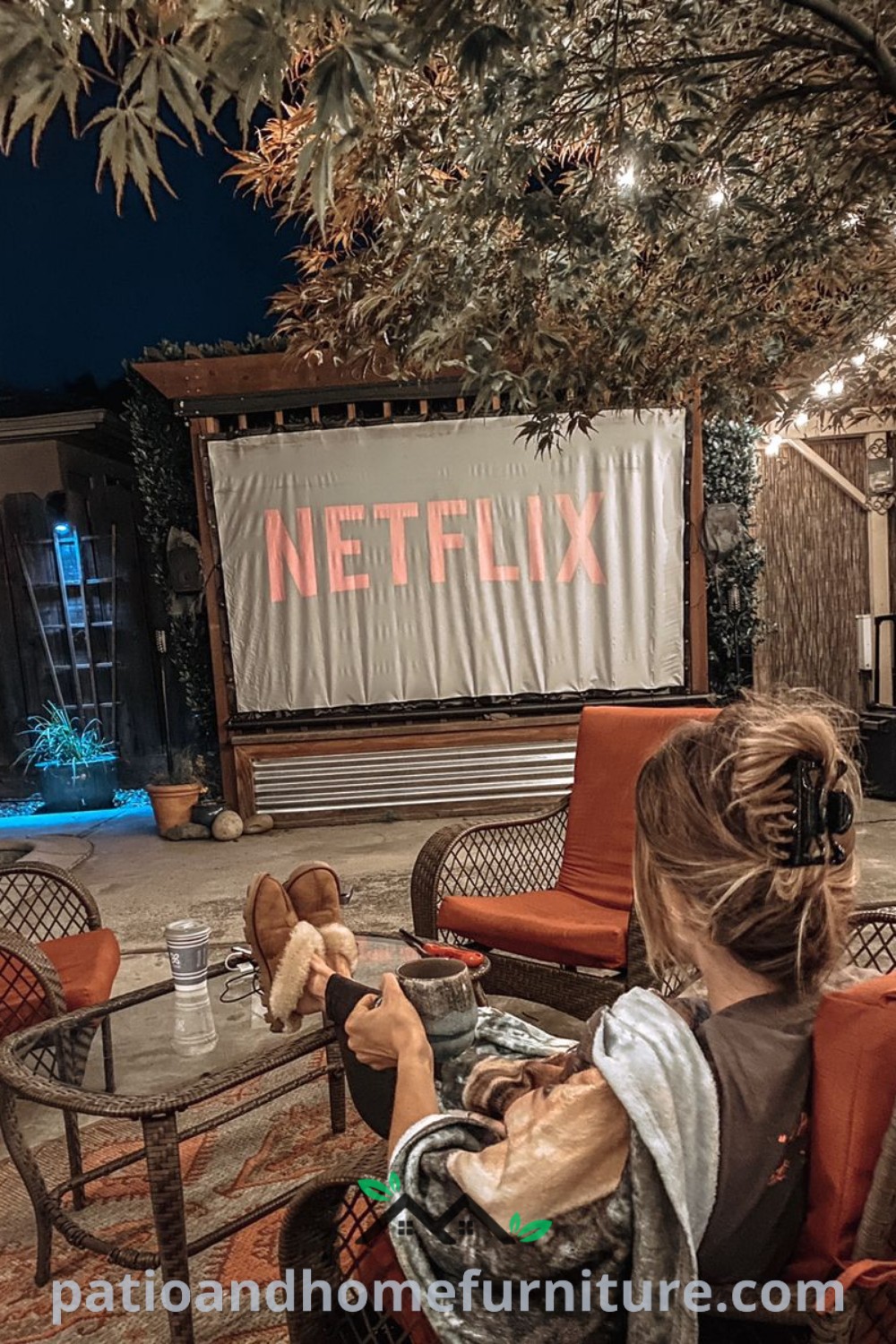 Backyard outdoor movie theater setup featuring a projector screen, cozy seating, and ambient lighting, creating an inviting atmosphere perfect for family gatherings or romantic evenings, detailed with decor ideas from wellnesswink.com.
