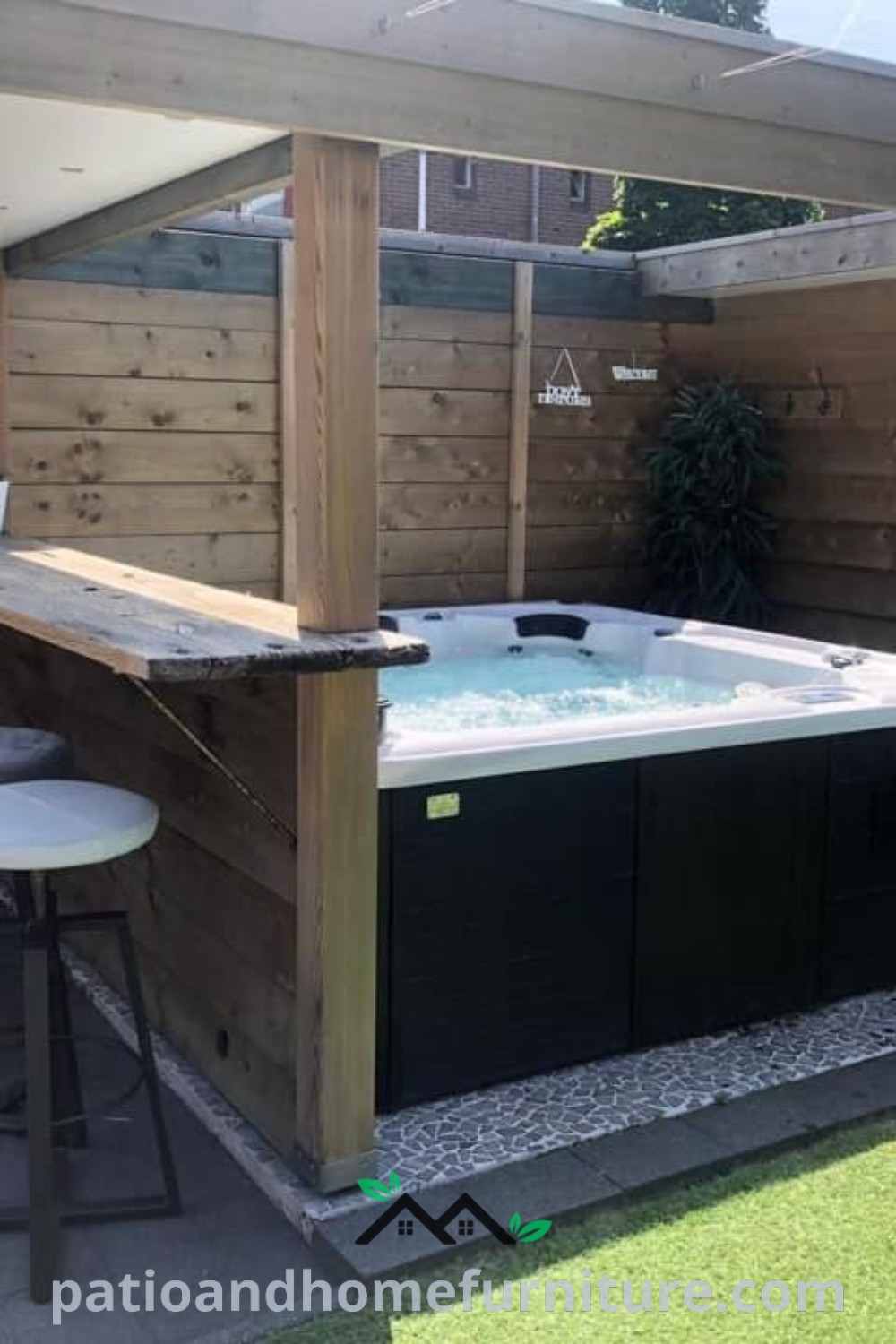 Outdoor hot tub surrounded by a wooden fence and bar stools, ideal for relaxation and entertaining, featuring cozy design ideas and decor inspirations for enhancing your backyard space, available at wellnesswink.com.
