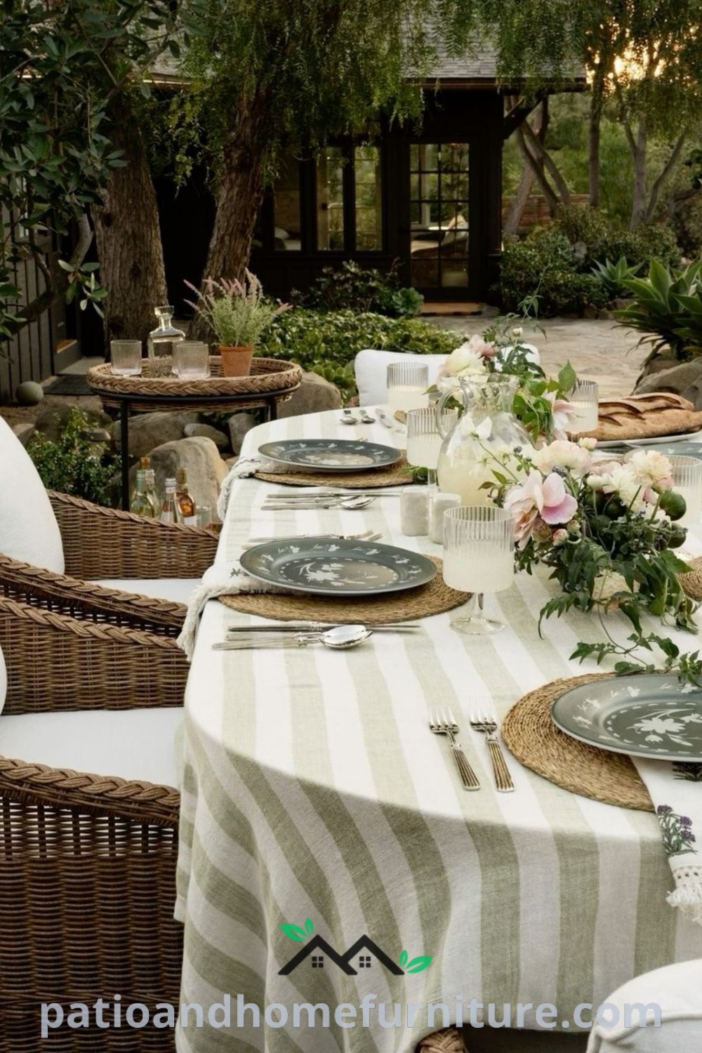 An inviting outdoor table set for dining, adorned with plates and place settings, surrounded by lush greenery, creating a cozy and captivating space perfect for backyard gatherings. For more cozy ideas, visit wellnesswink.com.