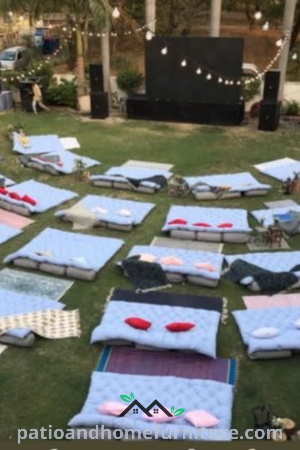 Cozy outdoor movie night scene with mattresses laid out on grass, decorated with fairy lights and inviting snacks, creating a delightful backyard atmosphere perfect for children’s movie parties, featured on wellnesswink.com.