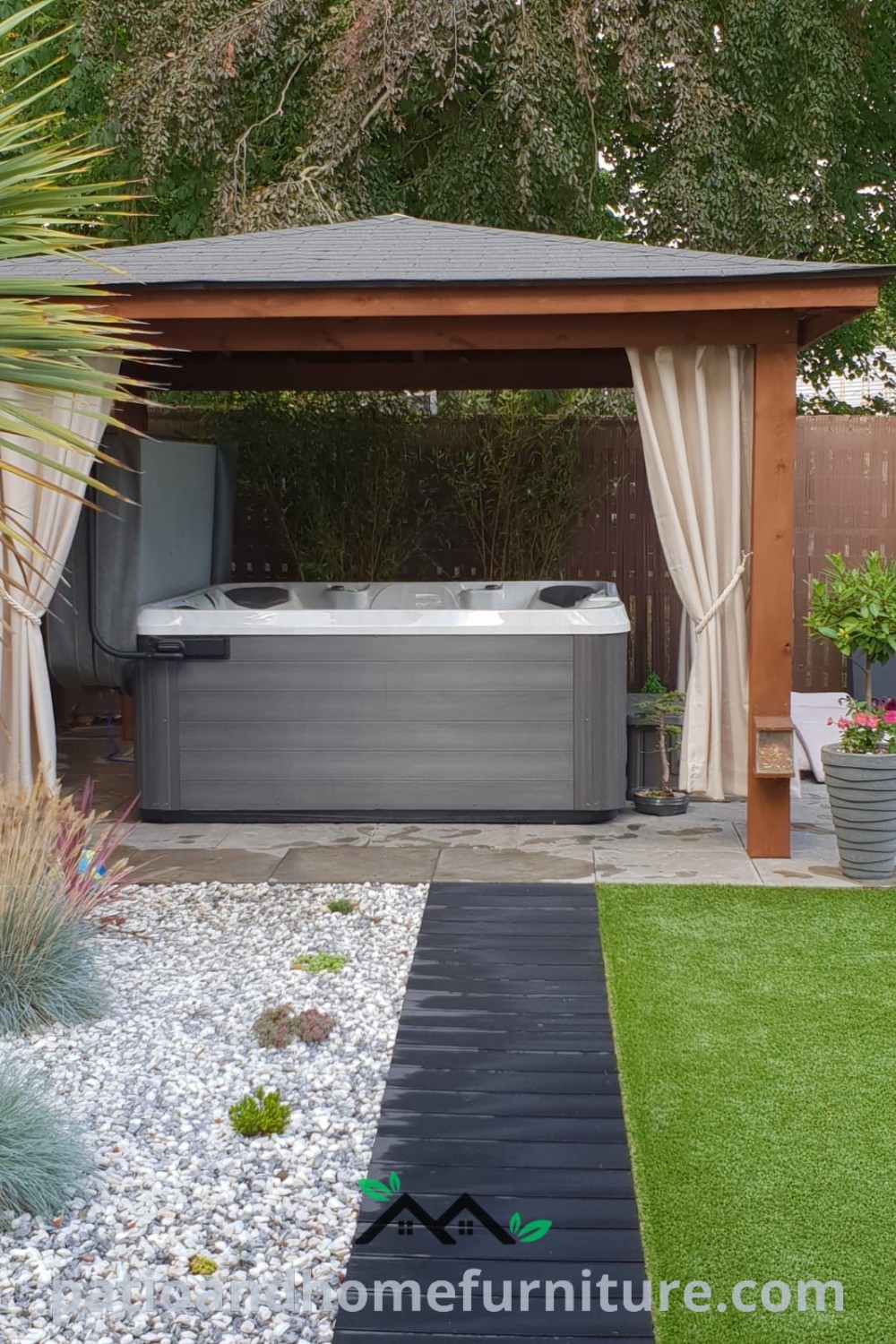 Cozy outdoor hot tub surrounded by garden plants and grass, with a gazebo for privacy and ambiance, offering fantastic design ideas for home wellness at wellnesswink.com.