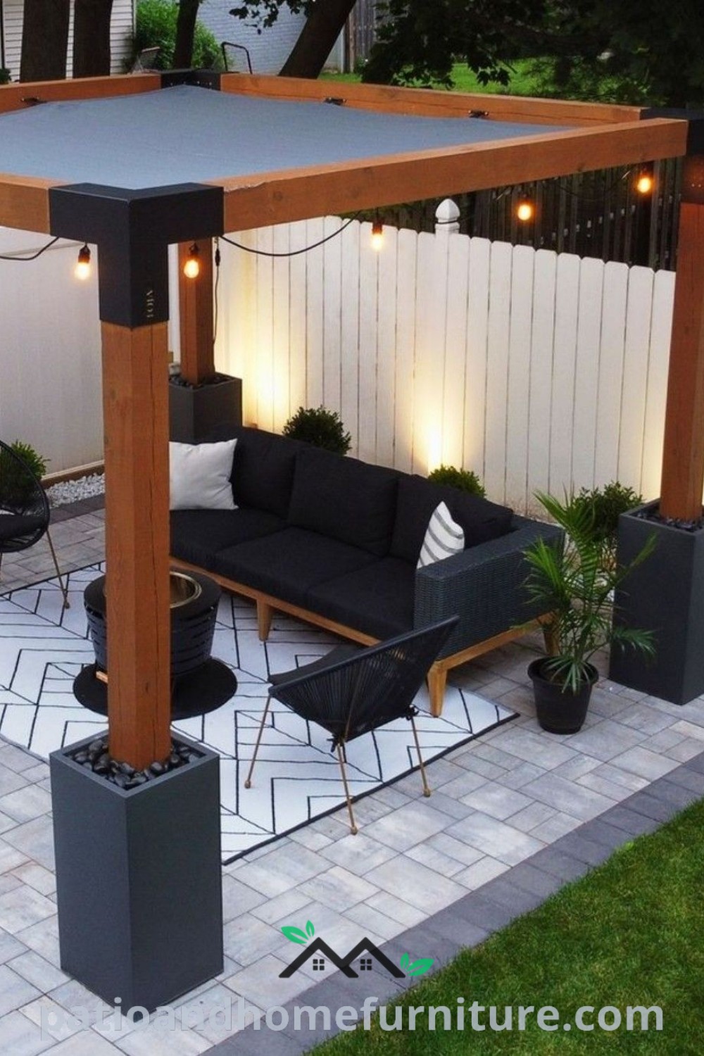 Cozy outdoor living area with black furniture and a stylish pergola illuminated by string lights, featuring decor ideas for a relaxing backyard oasis, enhancing the ambiance with colorful cushions and plants; visit wellnesswink.com for inspiration.