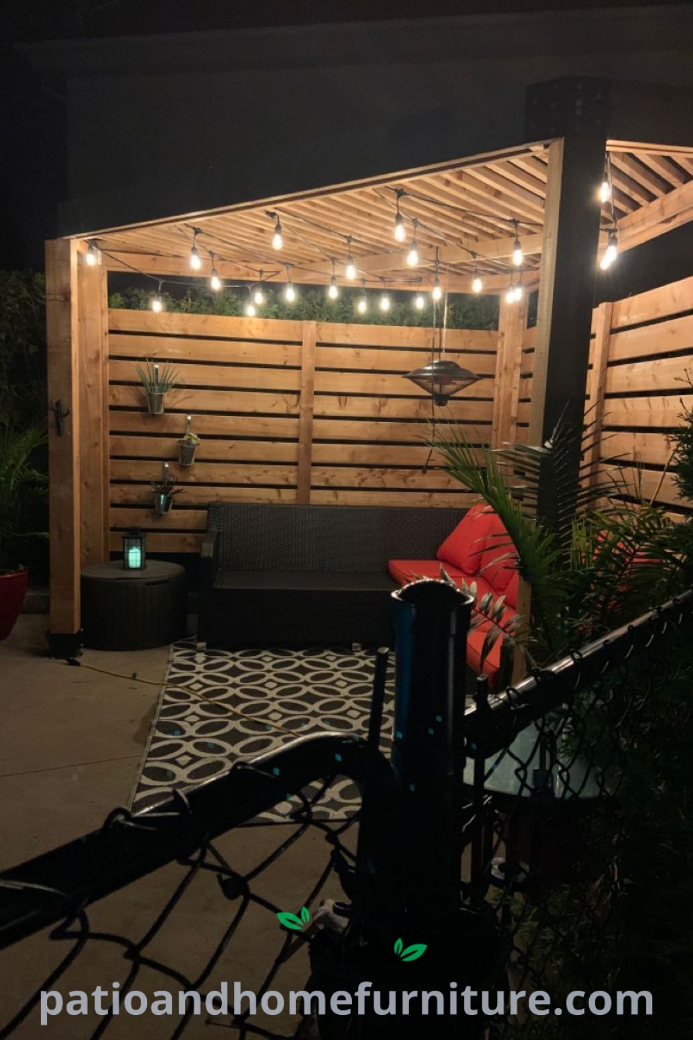 Cozy outdoor patio featuring string lights, comfortable furniture, and a charming triangle pergola, creating an inviting atmosphere for evening gatherings and relaxation, perfect for inspiring home decor ideas on wellnesswink.com.