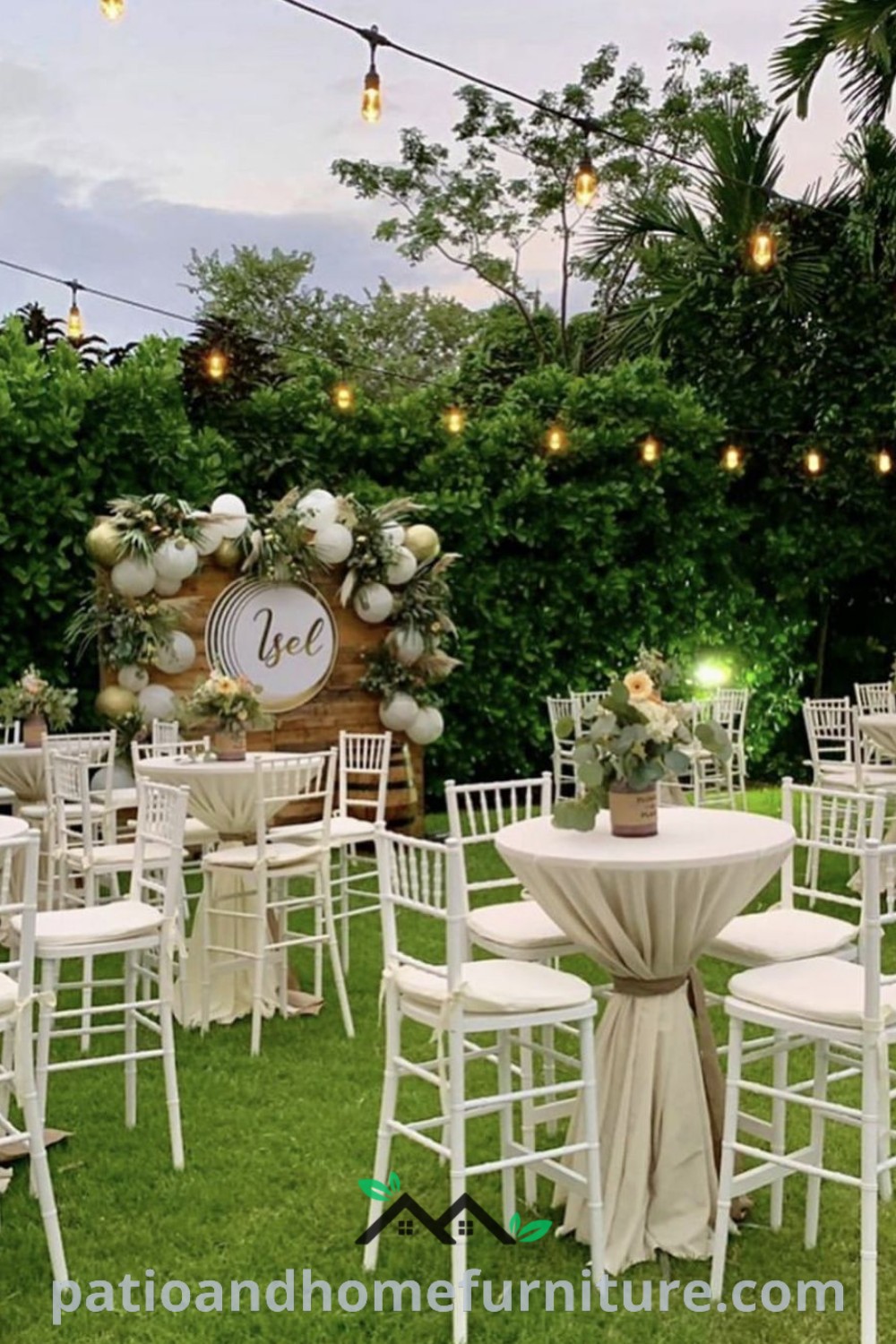 Backyard cocktail reception setup with tables and chairs on grass, colorful decorations, and ambient lighting for a cozy and inviting atmosphere, featuring floral centerpieces and string lights, from wellnesswink.com.